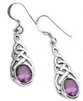 Silver celtic knot earrings with purple amethyst gemstones laying flat on a white background
